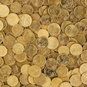 A close-up shot of Euro coins scattered in a pile, showcasing a rich golden texture.