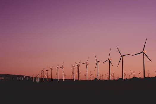 Silhouetted wind turbines at sunset in Zahara de los Atunes, Spain.