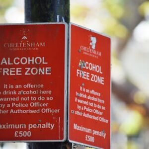 Close-up of red Cheltenham alcohol-free zone sign with maximum penalty warning.