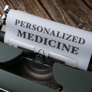 Close-up of a vintage typewriter with paper displaying 'Personalized Medicine' text.
