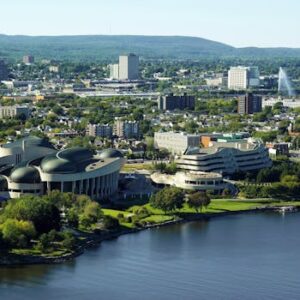 Aerial cityscape of Ottawa and Gatineau with modern architecture and lush greenery.
