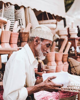 Senior man selling handmade wooden crafts at an outdoor market, showcasing traditional craftsmanship.