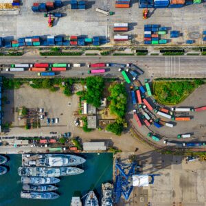 A vibrant aerial view of an industrial port with cargo containers in North Jakarta, Indonesia.