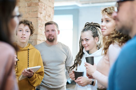 Diverse team engaged in a collaborative meeting in a contemporary office setting with natural lighting.
