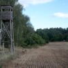 Scenic view of a wooden hunting tower in a rural field in Poland.
