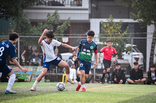 Intense football match in Hà Nội, showcasing dynamic play and teamwork on a vibrant turf field.