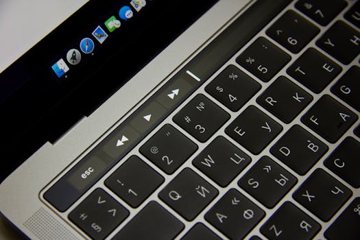 Close-up of a laptop keyboard showcasing Russian letters and a touch bar in a modern setting.