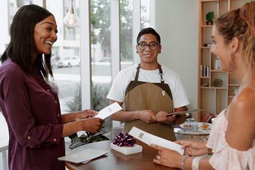 Three people enjoying conversation and exchanging letters in a stylish café.