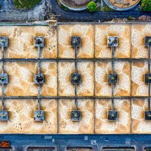 An aerial photo of a large industrial treatment plant in Indonesia, showcasing structured symmetry.