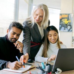 An adult team collaborating in an office environment, focusing on teamwork and diversity.