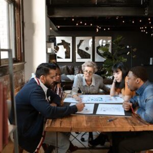 A diverse group of professionals brainstorming at a modern office table.