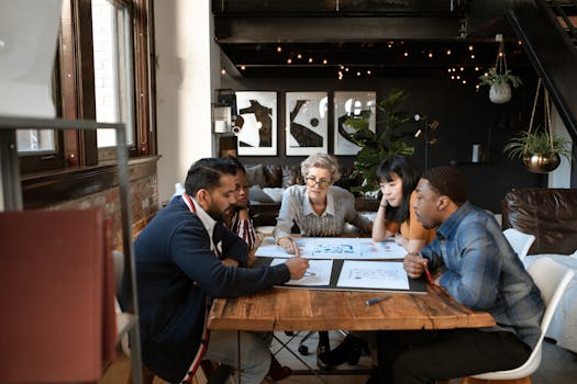 A diverse group of professionals brainstorming at a modern office table.