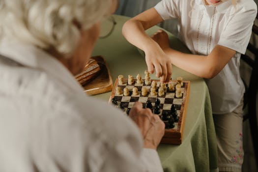 A close-up of hands playing chess, highlighting family bonding and strategic gameplay in a cozy home environment.