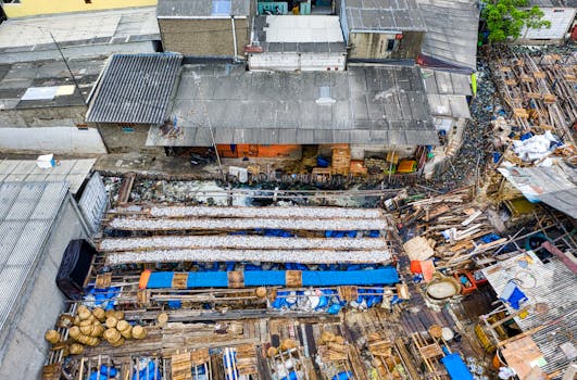Aerial view of a densely packed urban settlement in Jakarta, Indonesia, depicting housing and waste.
