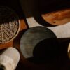 A flat lay of wooden kitchen utensils and woven materials in warm natural lighting, showcasing minimalist design.