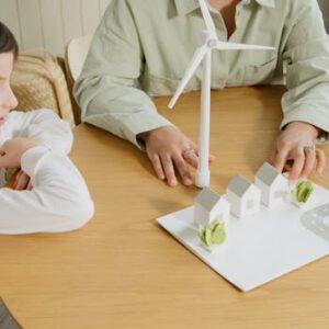A child explores renewable energy models in a classroom setting.