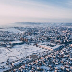 A stunning aerial view of Kruševac covered in snow during winter, showcasing urban architecture.