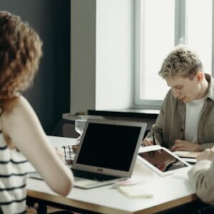 Diverse group of professionals engaged in a collaborative office meeting, focused on teamwork and project development.