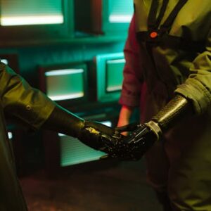 A compelling handshake featuring modern prosthetic arms in an industrial environment.