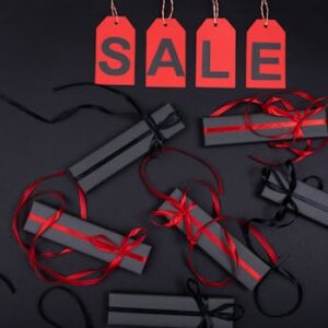 Elegant black gift boxes with red ribbons on sale promotion background.