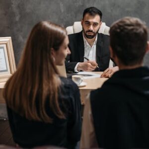 A business meeting with a professional advisor discussing documents in an office.