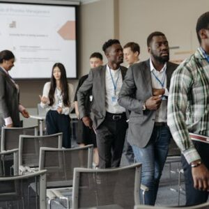 Diverse group of professionals attending a business conference in a modern conference room.