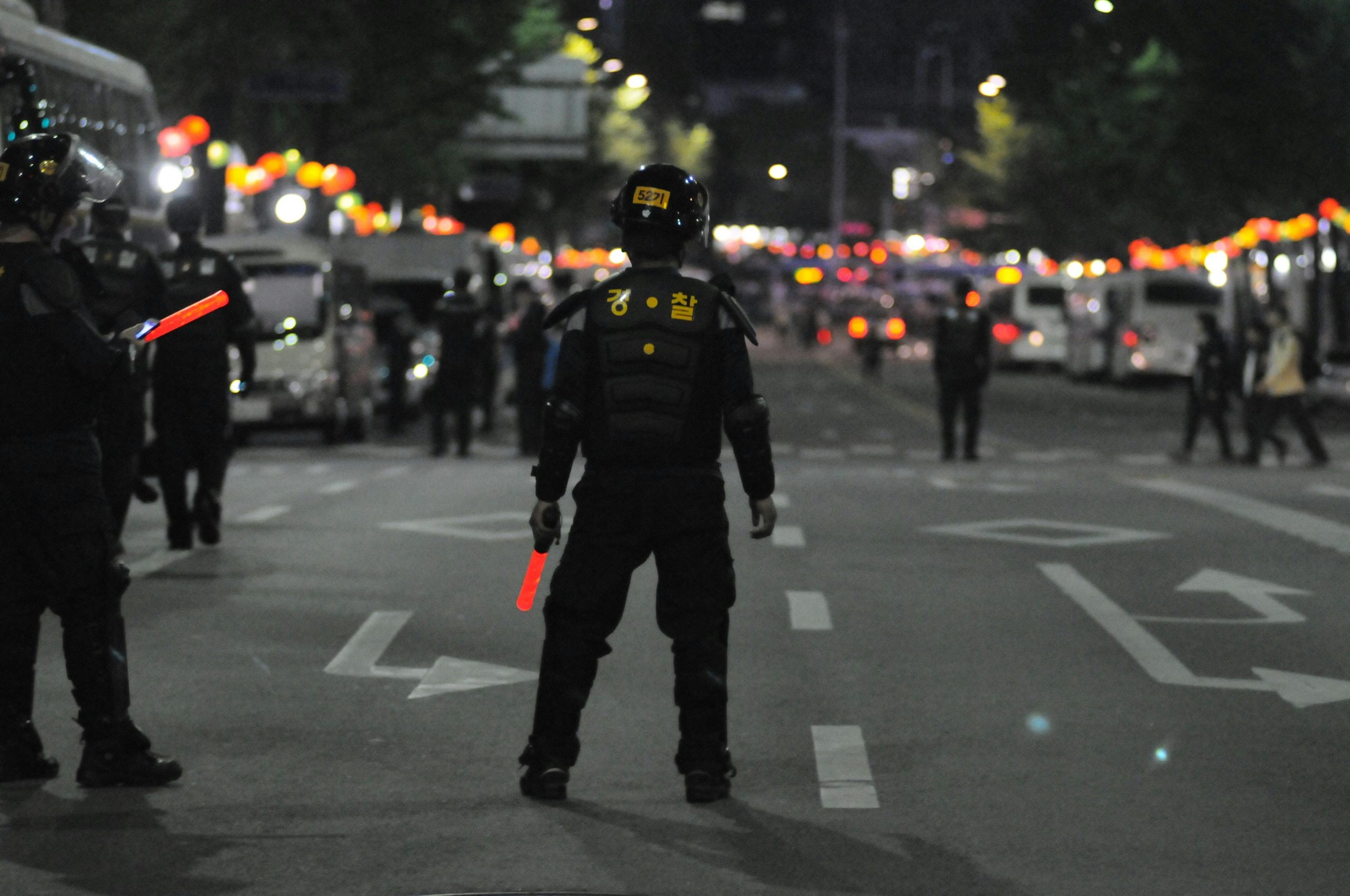 Police officers maintaining order during a night street patrol, ensuring public safety.