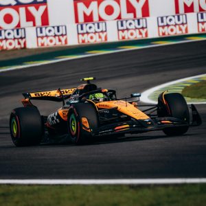 Dynamic Formula 1 race car speeding at São Paulo's iconic Interlagos circuit, showcasing thrilling motorsport action.