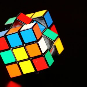 A close-up of a colorful Rubik's Cube puzzle, showcasing concentration and play.