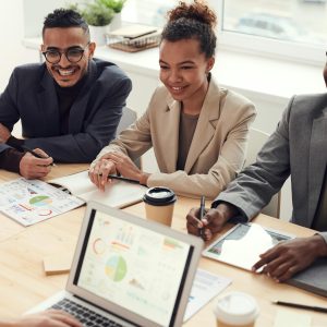 A diverse team of professionals having a meeting in a modern office setting, discussing business strategies.