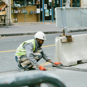 A construction worker operates on a city street in Paris, France, showcasing urban development.