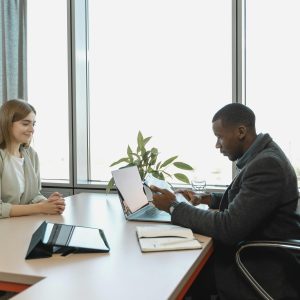 Business meeting with diverse professionals discussing a job opportunity.