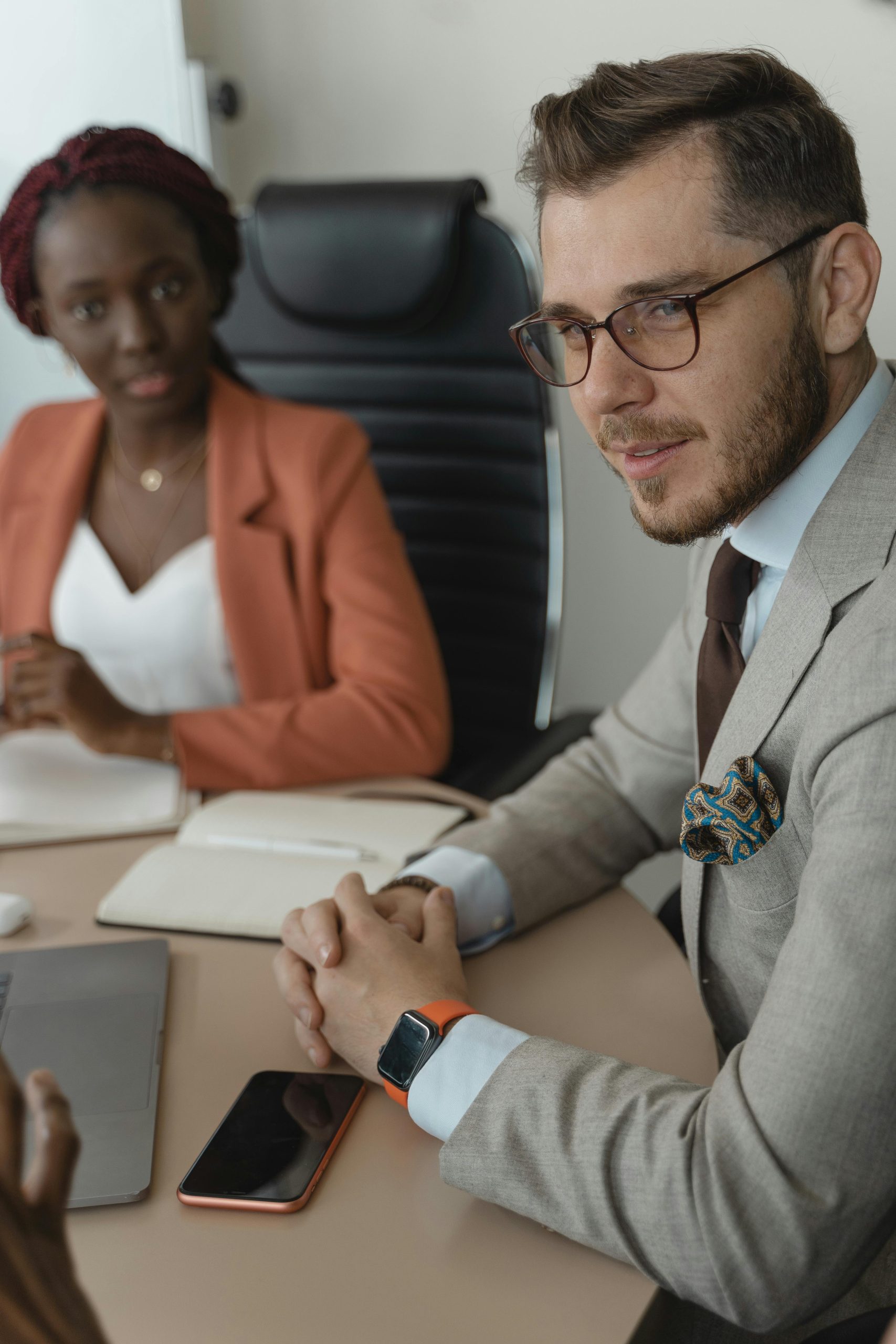 Two business professionals engaged in a meeting at the office.