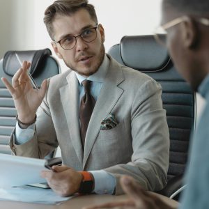 Two businessmen engaged in a professional meeting in a modern office setting.