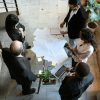Top view of a diverse team discussing plans over documents and laptops in an office setting.