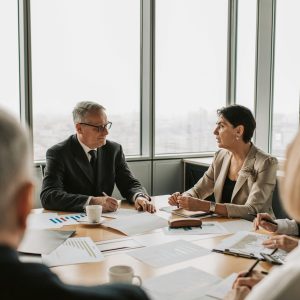 Business professionals engaged in a strategic meeting in a modern office setting with natural light.