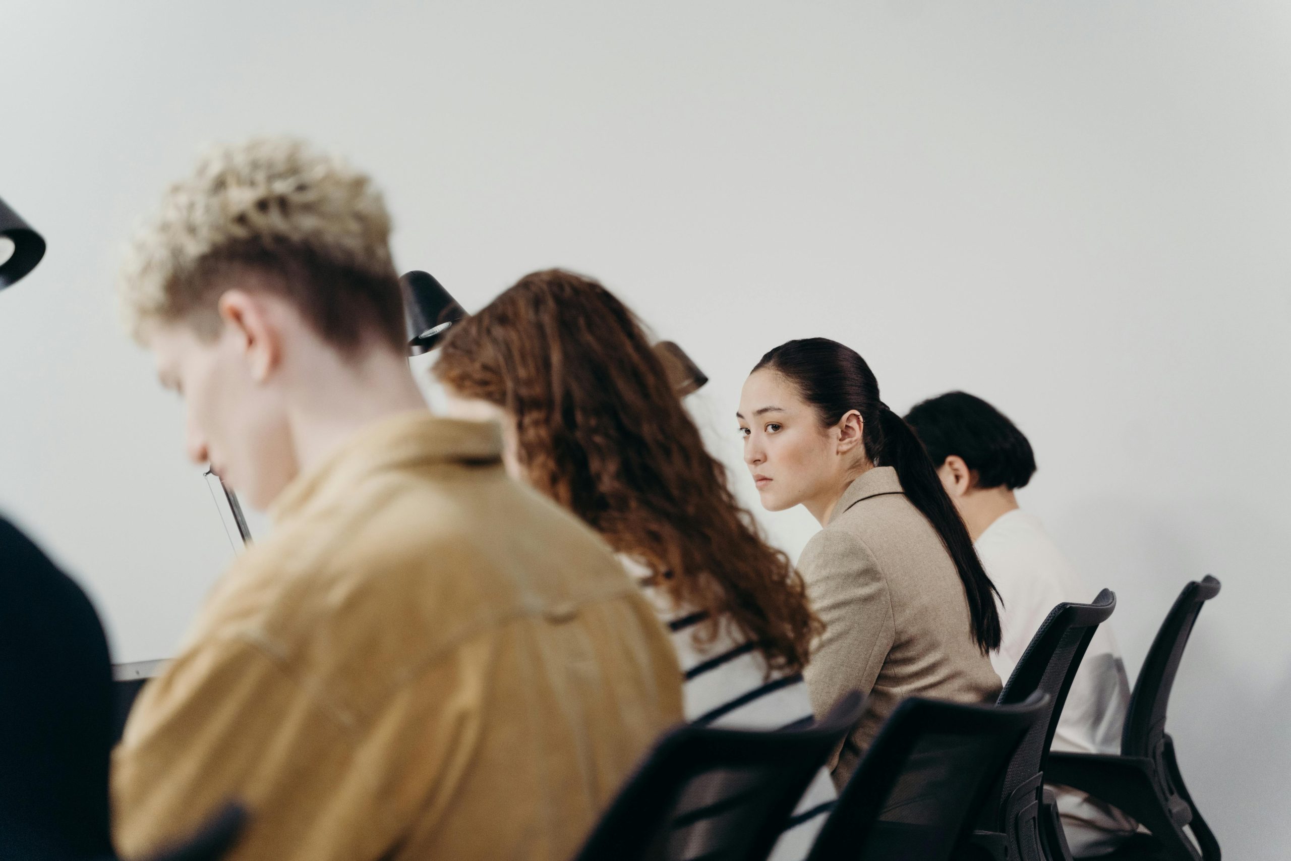 A multicultural office team engaged in focused work, emphasizing teamwork and diversity.