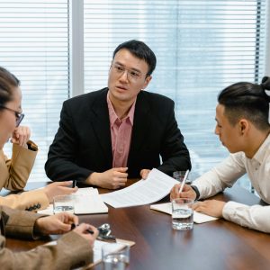 Team of professionals collaborating during a business meeting in a modern office setting.