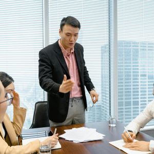 Business professionals discussing strategy during a corporate meeting in a modern boardroom.