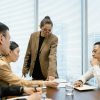 Diverse colleagues engage in a focused business meeting with leadership guidance.