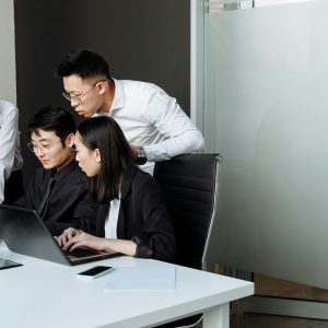 Team of professionals engaged in a collaborative business meeting in a modern office setting.