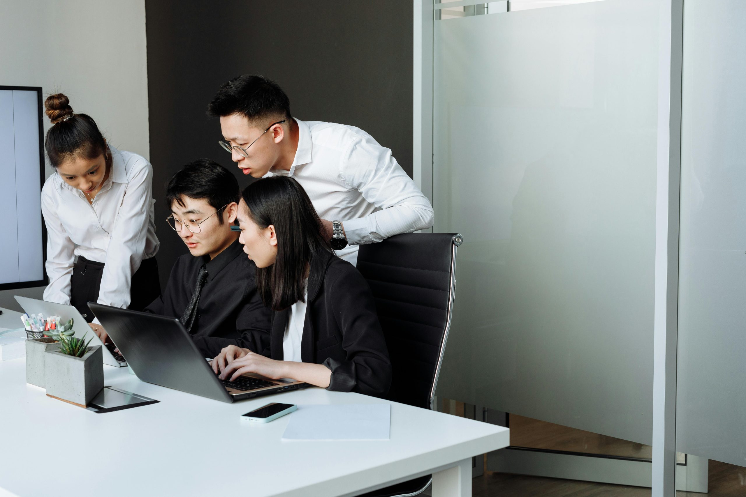 Team of professionals engaged in a collaborative business meeting in a modern office setting.