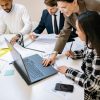 Diverse team working together on a project in a modern office environment.