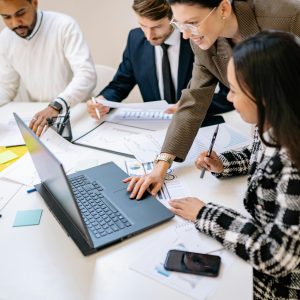 Diverse team working together on a project in a modern office environment.
