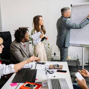 Business professionals brainstorming and collaborating during a team meeting in a modern conference room.